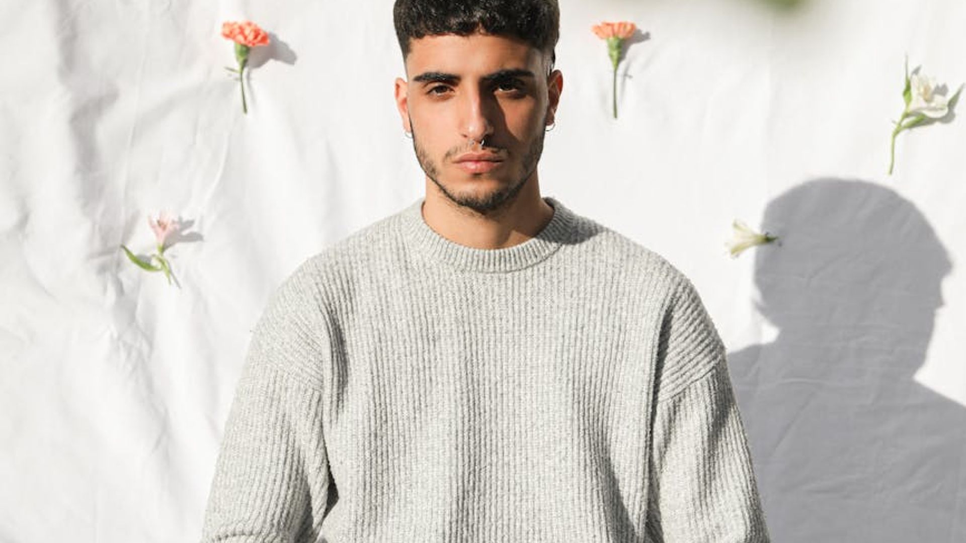 Silhouette of a person in a serene yoga pose against a dark, minimalist background.